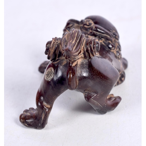 1450 - A JAPANESE CARVED HARDWOOD FIGURE OF A TEMPLE DOG.  3.4cm x 5.6 cm x 3.4cm, weight 20.8g