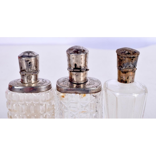 1465 - THREE SILVER MOUNTED SCENT BOTTLES.  Largest 8.8 cm x 3cm (3)