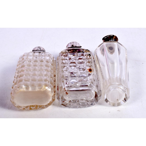 1465 - THREE SILVER MOUNTED SCENT BOTTLES.  Largest 8.8 cm x 3cm (3)