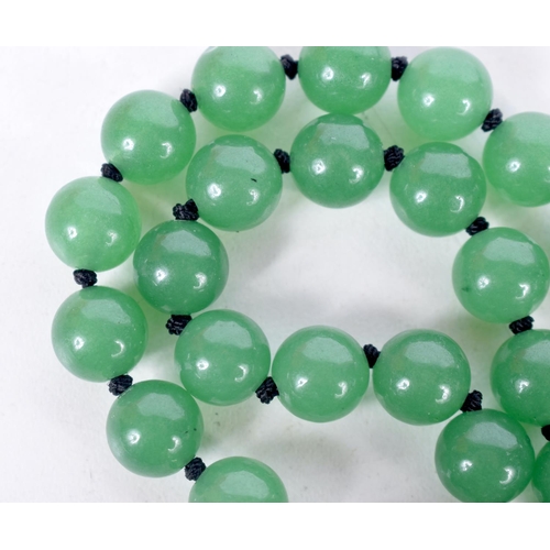 1517 - A GREEN JADE BEAD NECKLACE.  70cm long, bead size 9.6mm, weight 84g