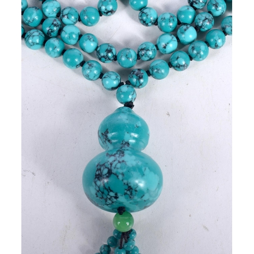 1518 - A TURQUOISE BEAD PENDANT NECKLACE.  84cm long, bead size 7.9mm, Pendant 4.1cm long, weight 105g