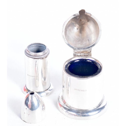 1521 - AN EARLY 20TH CENTURY SILVER MUSTARD POT WITH BLUE GLASS LINER TOGETHER WITH A MATCHING SALT POT.  H... 