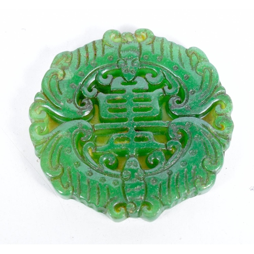 1540 - A CARVED GREEN JADE ROUNDEL/  7cm x 0.7cm, weight 64g