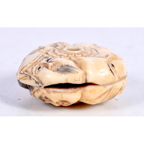 1543 - A CHINESE BONE NETSUKE CARVED WITH FACES.  4cm x 1.6 cm, weight 27g