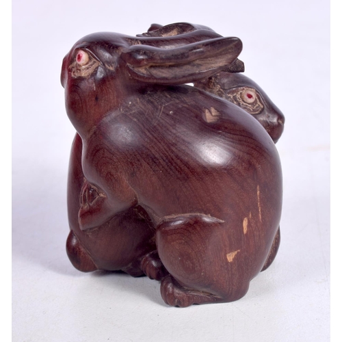 1547 - A JAPANESE NETSUKE CARVED AS 2 RABBITS.  5cm x 4.3cm x 4.3cm, weight 40g