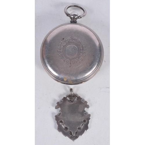 1569 - A SILVER WATCH AND FOB. Chester 1869. 76 grams overall. Largest 4.25 cm wide. (2)