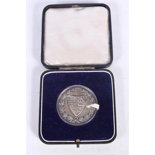 1609 - A CASED SILVER MEDAL. Birmingham 1928. 29.2 grams. 4 cm wide.