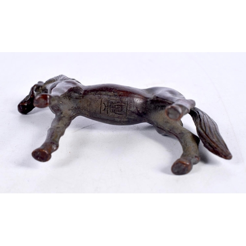 1621 - A JAPANESE BRONZE HORSE OKIMONO. 128 grams. 7cm x 7cm.