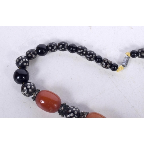 1645 - AN EASTERN AMBER NECKLACE. 74 grams. 42 cm long, largest bead 2.5 cm x 2 cm.