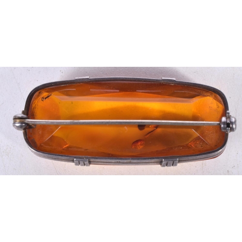 1670 - AN AMBER BROOCH. 12.9 grams. 5.5 cm x 2.5 cm.