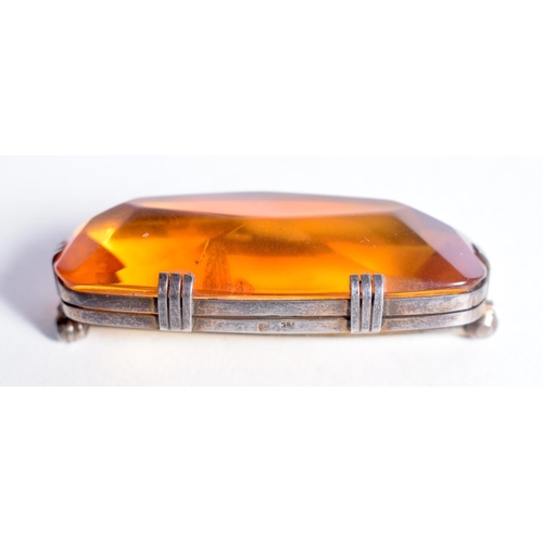 1670 - AN AMBER BROOCH. 12.9 grams. 5.5 cm x 2.5 cm.