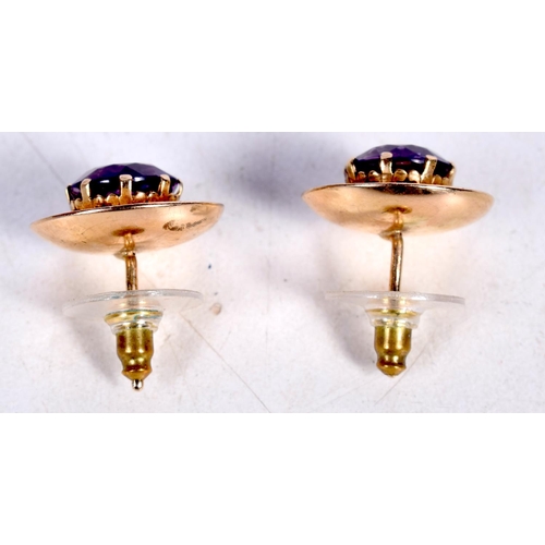 1678 - A PAIR OF YELLOW METAL AND AMETHYST EARRINGS. 5.5 grams. 2 cm wide.