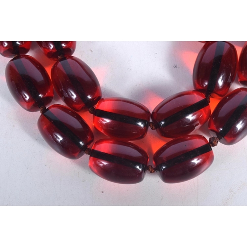 1682 - A CHERRY AMBER TYPE NECKLACE. 206 grams. 88 cm long.