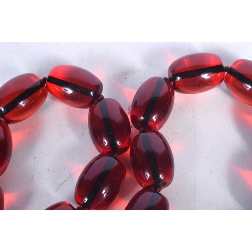 1682 - A CHERRY AMBER TYPE NECKLACE. 206 grams. 88 cm long.