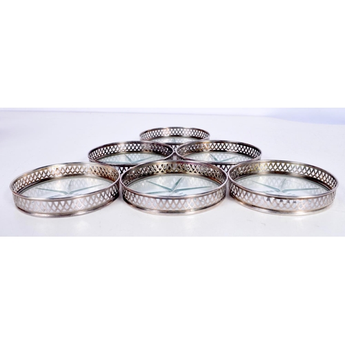 1707 - SIX SILVER AND GLASS COASTERS. 187 grams overall. 8 cm diameter. (6)