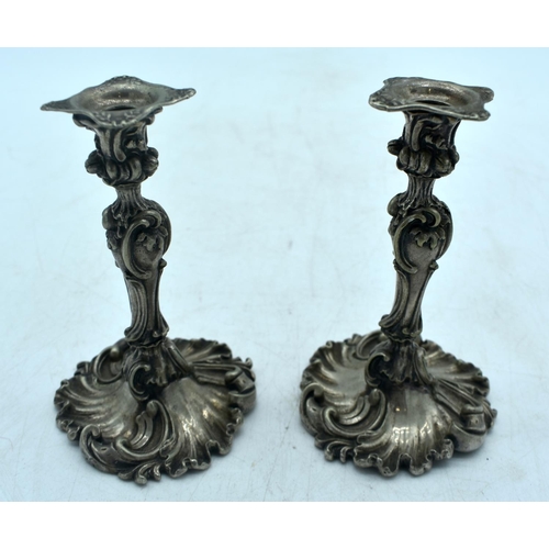 1775 - A SMALL PAIR OF ANTIQUE CONTINENTAL SILVER PLATED CANDLESTICKS. 421 grams. 11.5 cm high.