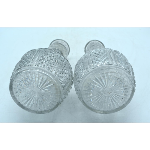 1784 - A PAIR OF REGENCY CUT GLASS DECANTERS with silver decanter labels. 25 cm high.