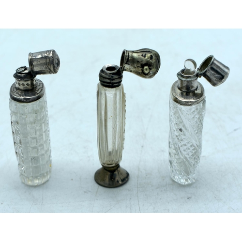 1821 - THREE CONTINENTAL SILVER TOPPED SCENT BOTTLES.  Largest 9.9cm x 4.3cm (3)