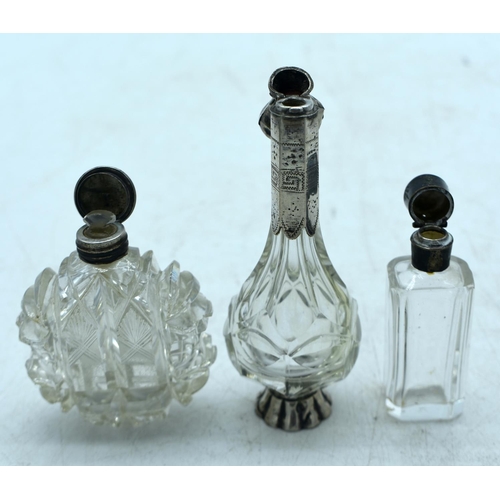 1822 - THREE CONTINENTAL SILVER TOPPED SCENT BOTTLES.  Largest 12.2 cm x 4cm (3)