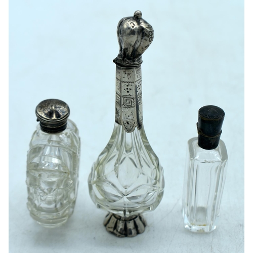 1822 - THREE CONTINENTAL SILVER TOPPED SCENT BOTTLES.  Largest 12.2 cm x 4cm (3)