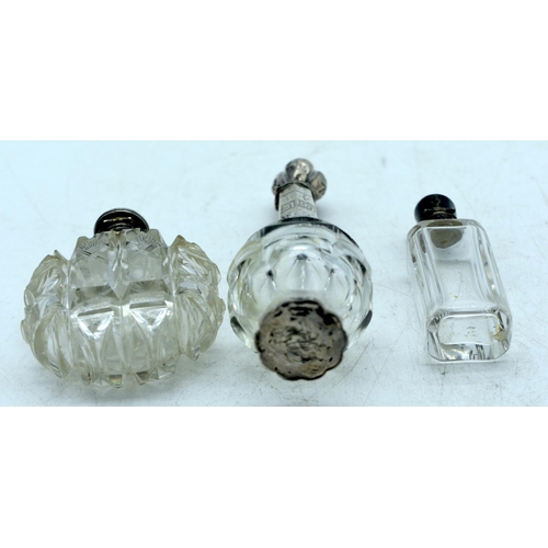 1822 - THREE CONTINENTAL SILVER TOPPED SCENT BOTTLES.  Largest 12.2 cm x 4cm (3)