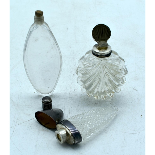 1823 - THREE CONTINENTAL SILVER TOPPED SCENT BOTTLES.  Largest 10.7cm x 4.3cm (3)