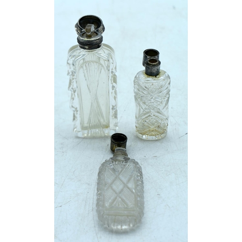 1825 - THREE CONTINENTAL SILVER TOPPED SCENT BOTTLES.  Largest 10.6 cm x 4.1cm (3)