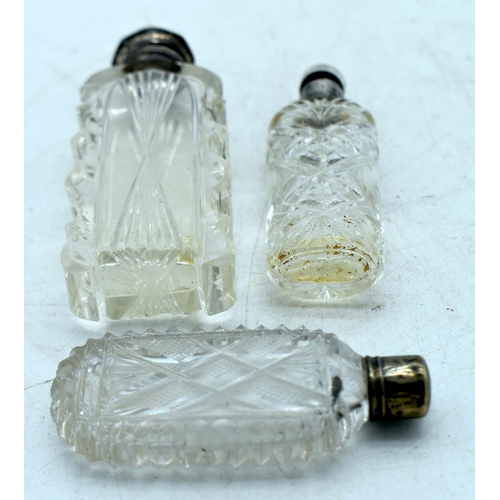 1825 - THREE CONTINENTAL SILVER TOPPED SCENT BOTTLES.  Largest 10.6 cm x 4.1cm (3)