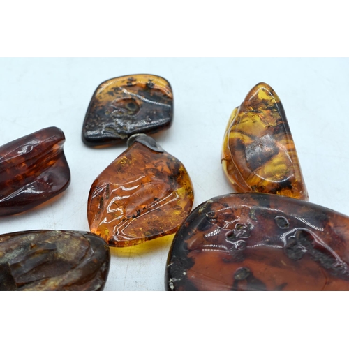 1845 - SEVEN AMBER TYPE DECORATIVE PEBBLES.  Largest 11.8 cm x 7cm x 2.5cm (7)