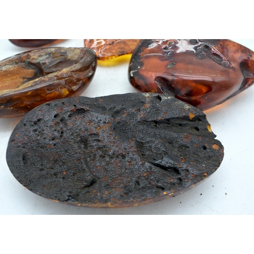 1845 - SEVEN AMBER TYPE DECORATIVE PEBBLES.  Largest 11.8 cm x 7cm x 2.5cm (7)