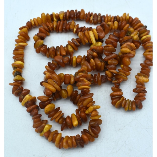 1848 - THREE AMBER COLOURED BEAD NECKLACES.  Longest 148cm (3)