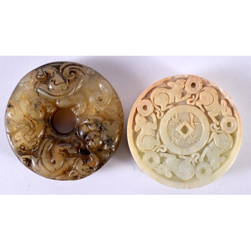 1872 - TWO CARVED JADE ROUNDELS.  Largest 5.5cm x 1.2 cm, total weight 131g (2)