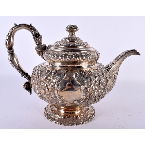 1958 - AN EARLY 19TH CENTURY SILVER REPOUSSE TEAPOT AND COVER. London 1818. 1238 grams. 30cm x 20cm.