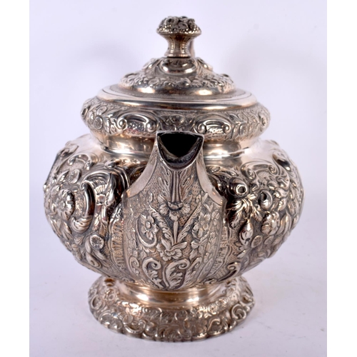 1958 - AN EARLY 19TH CENTURY SILVER REPOUSSE TEAPOT AND COVER. London 1818. 1238 grams. 30cm x 20cm.