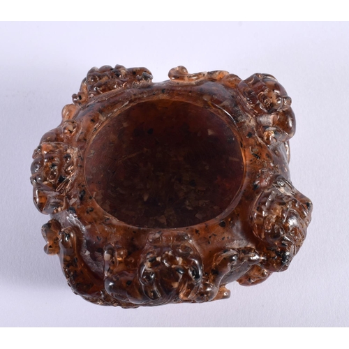 2005 - A CHINESE QING DYNASTY CARVED AMBER SCHOLARS BRUSH WASHER overlaid with clambering buddhistic lions.... 