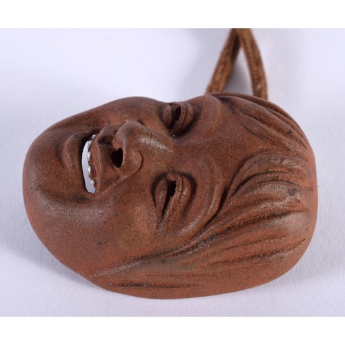 2007 - A RARE 19TH CENTURY JAPANESE MEIJI PERIOD POTTERY MASK HEAD NETSUKE with enamelled teeth. 5.25 cm x ... 