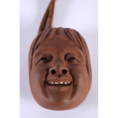 2007 - A RARE 19TH CENTURY JAPANESE MEIJI PERIOD POTTERY MASK HEAD NETSUKE with enamelled teeth. 5.25 cm x ... 