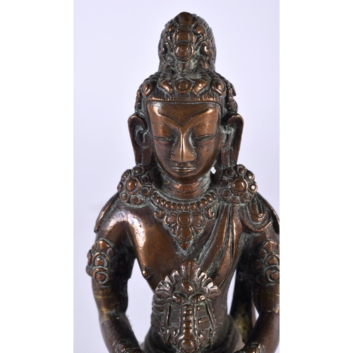 2051 - A GOOD 18TH CENTURY TIBETAN NEPALESE BRONZE FIGURE OF A SEATED BUDDHA modelled holding a stupa, upon... 