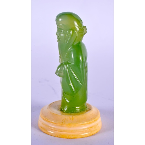 2067 - A CHINESE REPUBLICAN PERIOD CARVED GREEN JADE FIGURE OF AN IMMORTAL modelled holding a peach. 7.5 cm... 