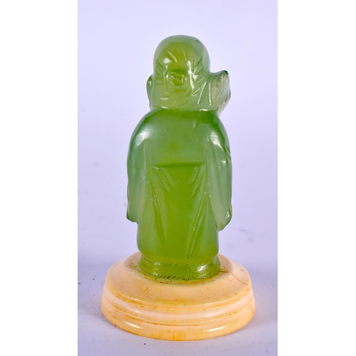 2067 - A CHINESE REPUBLICAN PERIOD CARVED GREEN JADE FIGURE OF AN IMMORTAL modelled holding a peach. 7.5 cm... 