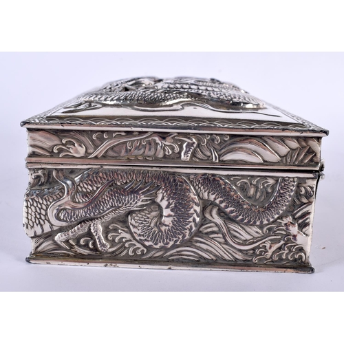 2080 - A LARGE 19TH CENTURY JAPANESE MEIJI PERIOD WHITE METAL DRAGON CASKET AND COVER decorated in relief w... 