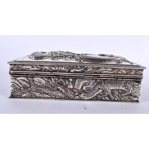 2080 - A LARGE 19TH CENTURY JAPANESE MEIJI PERIOD WHITE METAL DRAGON CASKET AND COVER decorated in relief w... 