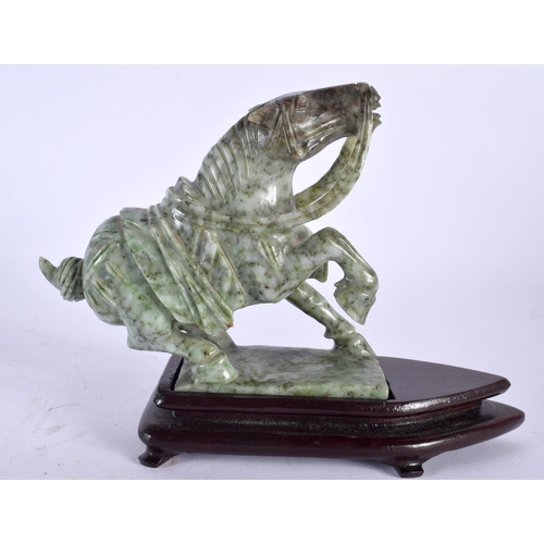 2125 - AN EARLY 20TH CENTURY CHINESE CARVED JADE FIGURE OF A HORSE Late Qing/Republic. 15cm x 15cm.