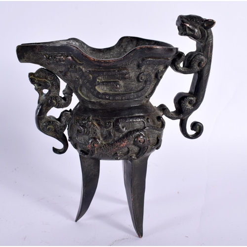 2143 - A CHINESE QING DYNASTY BRONZE JUE WINE VESSEL decorated with dragons and beasts. 14cm x 10 cm.