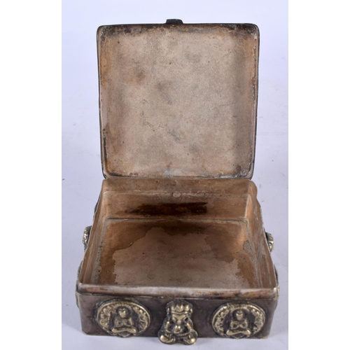 2210 - AN EARLY 20TH CENTURY INDO TIBETAN WHITE METAL SQUARE FORM TRAVELLING BOX overlaid with buddhistic f... 