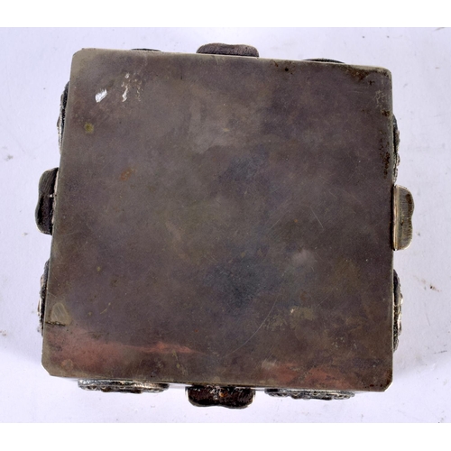 2210 - AN EARLY 20TH CENTURY INDO TIBETAN WHITE METAL SQUARE FORM TRAVELLING BOX overlaid with buddhistic f... 