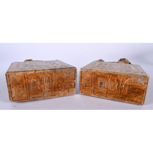 2214 - AN UNUSUAL PAIR OF 19TH CENTURY CHINESE CARVED SOAPSTONE FIGURAL SEALS Qing, formed with seated figu... 