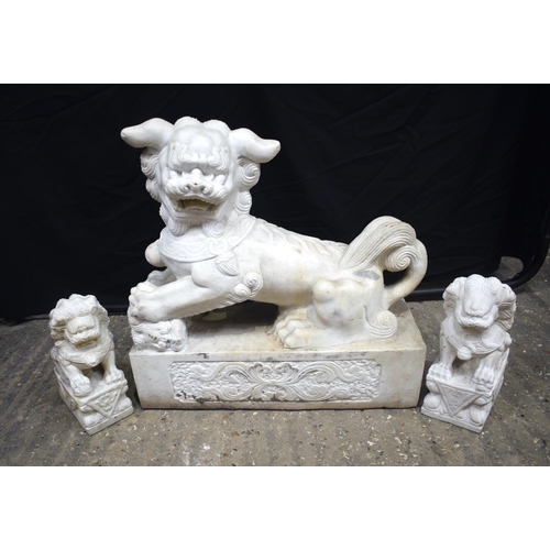 A large carved marble Foo dog together with 2 smaller carvings