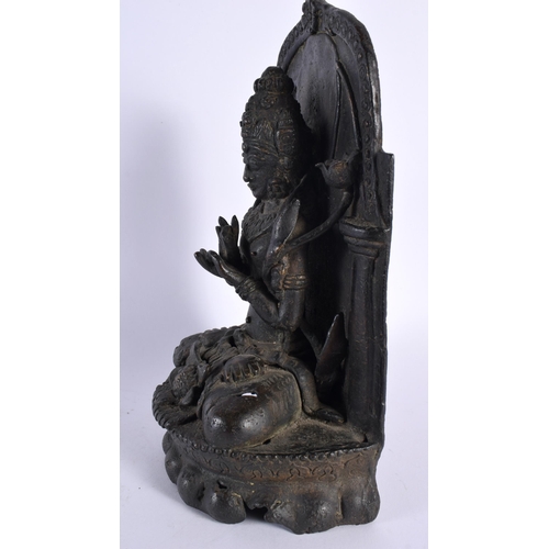 107 - A 17TH/18TH CENTURY INDIAN TIBETAN BRONZE FIGURE OF A BUDDHA modelled with legs crossed, seated in f... 