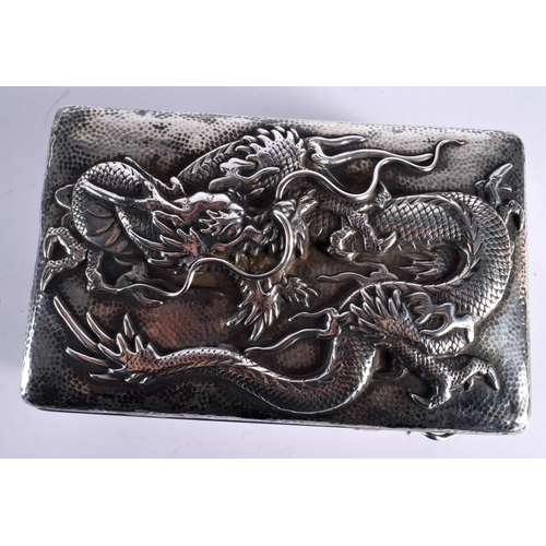 128 - A LATE 19TH CENTURY JAPANESE MEIJI PERIOD EMBOSSED HAMMERED SILVER BOX AND COVER decorated with drag... 